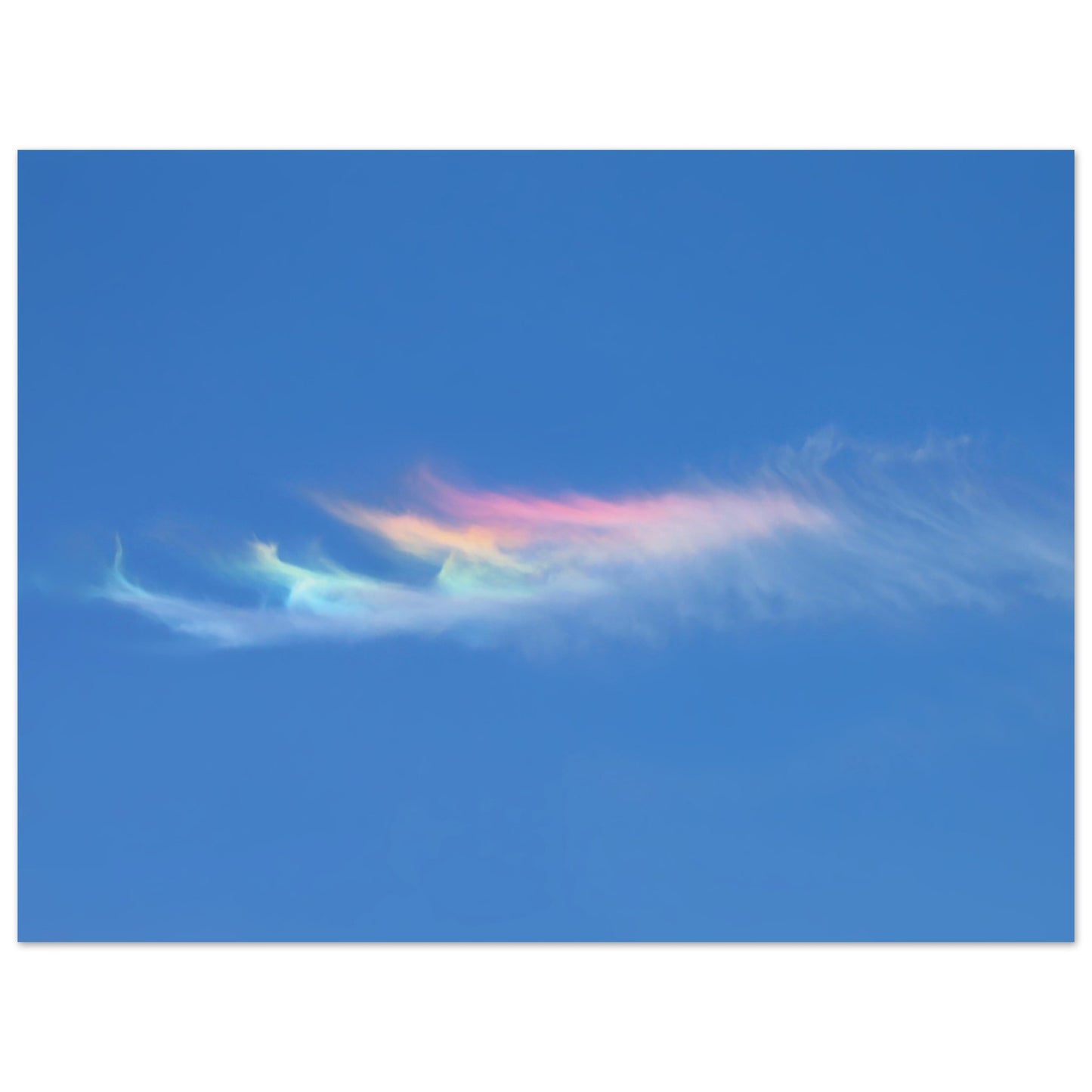 Photographic print capturing a blue sky adorned with a rainbow colored cloud taken in Marfa Texas by Allison Cartwright , Found Art Studio.