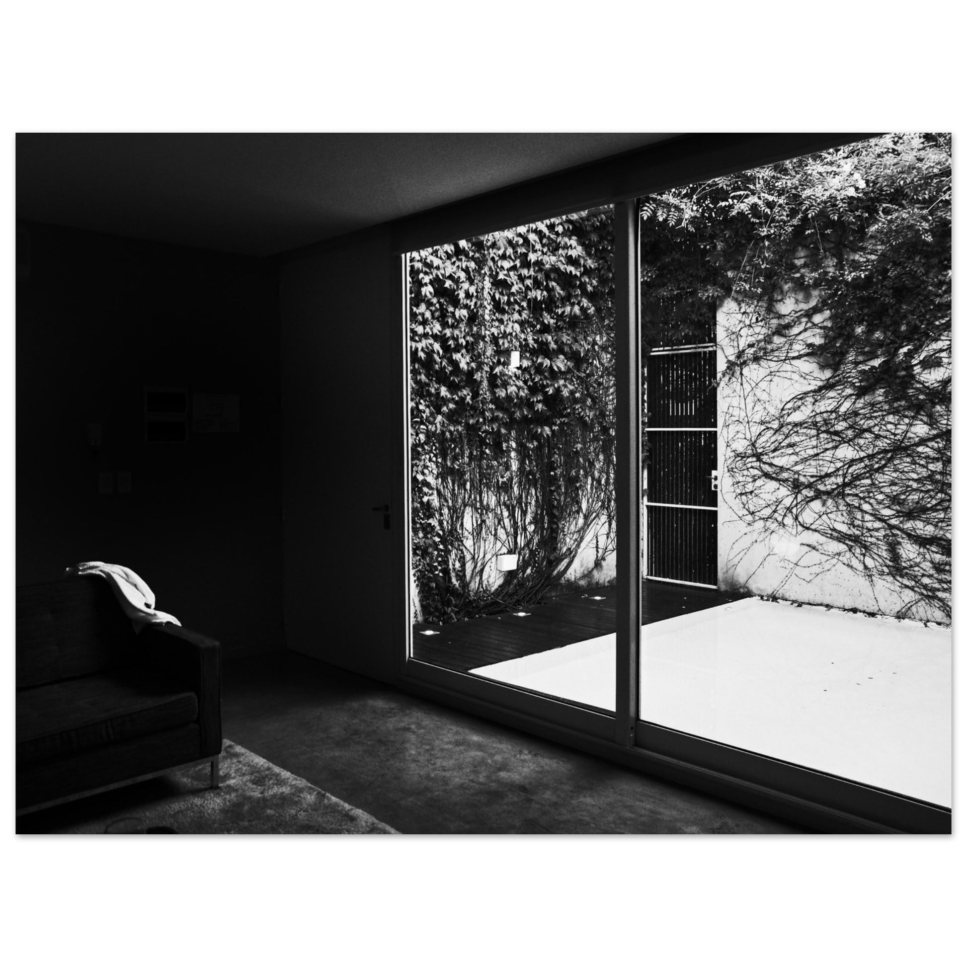 Photographic Print of a Dramatic Black and White Chair facing a Courtyard  Scene by Allison Cartwright Found Art Studio