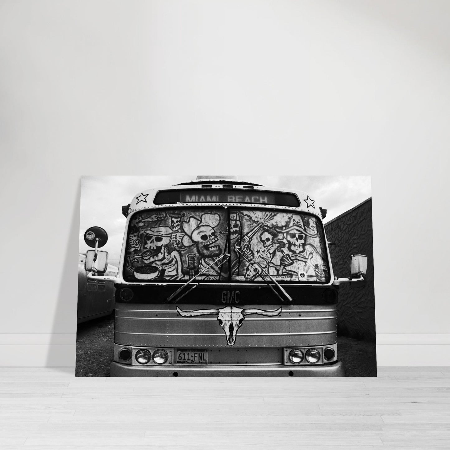 Photographic Print of the front of a Terlingua bus with skeletons driving to Miami Beach in black and white by Allison Cartwright Found Art Studio